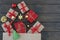 Top view of gift boxes tired with ribbon, new year stuff look out from paper bag on wooden background, copyspace for text.