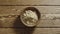 TOP VIEW: Ginger powder fill wooden cup on a wooden table