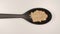 TOP VIEW: Ginger powder in a plastic spoon on a table