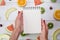 Top view of girl`s hands, placed on white desktop with fruits.