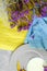 Top view of a glass of vanilla smoothie on a colorful background. Blue and yellow fabric with purple flowers. A white