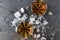 Top view of glasses with brandy and pieces of ice on gray surface.Party drinks