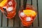 Top of view of glasses of spritz aperitif aperol red cocktail with orange slices and ice cubes