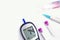 Top view glucose meter machine and numbers of glucose in the blood show on screen with sheet check, Blood tube, Needle pen,