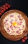 Top view gluten Free Pizza Carbonara with Bacon and Yolk of Chicken Egg and cherry tomatoes. Homemade food. Concept for a tasty