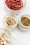 Top view of goji berries and sprouts in glass jars