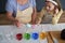 Top view of granddaughter and grandmother dyeing Easter eggs together