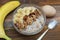 Top view of a Granola Bowl, Muesli with Oats, Nuts and Dried Fruit on Wooden table. Bannana, nuts, fruits. Healthy Breakfast. Diet