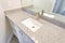 Top view of gray bathroom countertop with single basin sink and faucet