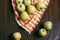 Top view of green apples on a wooden table and orange checkered