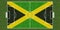 Top view of Green grass soccer field with flag of Jamaica. football background. 3d illustration