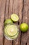 Top view green lime sliced in the soda water and glass place on the wooden table