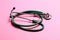 Top view of green medical stethoscope on colorful background with copy space. Medicine equipment concept