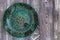 Top view green painted plate on wooden surface