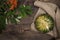 Top view of green pumpkin on burlap and red rowan on wooden background in rustic style. Happy Thanksgiving and Harvest