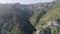 Top view of green slopes of mountain top covered with spruce and trees. Shot. Mountain landscape of green gorge on clear