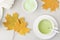 Top view of green tea matcha in a white mug. Matcha ginger latte. Concept - healthy autumn drinks.
