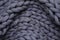 Top view of grey chunky knit blanket as background