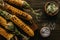 top view of grilled corn salt and butter with parsley on wooden