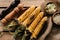 top view of grilled corn salt and pepper grinders on wooden table