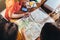 Top view of group of female students studying the map sitting at desk