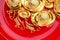 Top view group of golden ingots on red tray with fish pattern .C