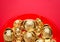 Top view group of golden ingots on red tray at red background. Ch