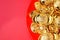 Top view group of golden ingots on red tray at red background.Chinese new year concept,leave space for adding