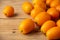 Top view of a group of kumquats on rustic wooden table, with selective focus, horizontal