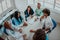 Top view of a group of multiethnic medical professionals including doctors, surgeons, and nurses are gathered in a