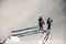 top view of group of skiers walking on deep white powdery snow