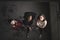 Top view of group of teenagers girl gang indoors in abandoned building, looking at camera.