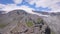 Top view of group of tourists vacationing on mountain route. Clip. Mountaineers line up along mountain rocky path on