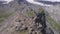 Top view of group of tourists vacationing on mountain route. Clip. Mountaineers line up along mountain rocky path on