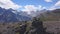 Top view of group of tourists vacationing on mountain route. Clip. Mountaineers line up along mountain rocky path on