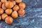 Top view of a group of whole hazelnuts on blue marble background in horizontal