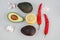 Top view of guacamole ingredients on grey background