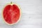 Top view, half cutted watermelon on white wooden table. From above.