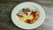 Top view on half-eaten decorated baked meat ribs with garnish on plate