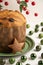 Top view of half panettone on green plate on white table with green Christmas balls, white background