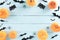 Top view of Halloween crafts, orange pumpkin, ghost, bat and spider on green pastel wooden background with copy space for text.