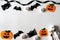 Top view of Halloween crafts, orange pumpkin, ghost and spider on white background