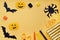 Top view of Halloween decorations, sewing items making textile pumpkin craft, handmade black bats, spider on orange background