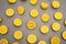 top view of halves of fresh and ripe lemons on grey.