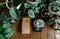Top View of Hand Drip Coffee,Barista Tools, Digital Scale and brown paper bag package of craft coffee with among plants at home