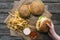 top view of hand with hamburgers, french fries and sauces on baking paper