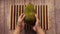 top view of hand hold a jackfruits on table.