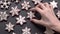 Top view of hand-laid gingerbread cookies snowflakes on slate table