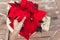 Top view of a hand touching vibrant red holiday Christmas pointsettia leaves