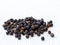 top view of handful of dried black pepper peppercorns, ripe piper nigrum fruits